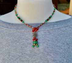 Handmade artisan Christmas beaded necklace gift for her.  This beautiful beaded Christmas necklace is loaded with different antique brass beads, a beautiful antique brass snowflake for the focal point, red and green metallic 11/0 miyuki seed beads, green and red czech glass beads in different shapes.  Made on very strong beading wire.  Has a lobster clasp.  If you need an extender chain just message me.  I usually ship in a brown jewelry box so if you want a Christmas box just let me know.  Everything is nickel free.  This statement necklace makes great Christmas gifts for her. To visit my Etsy store click here: https://www.etsy.com/shop/BNJewelryAndArtwork Here Are A Few Details about my handmade jewelry: * I use very strong bead stringing wire for my necklaces * No two are alike * I use Christmas Jewelry Diy Necklace, Christmas Necklace Ideas, Christmas Necklace Diy, Christmas Beaded Necklace, Christmas Bead Necklace, Christmas Jewelry Diy, Rare Beads, Snowflake Necklace, Snowflake Pendant