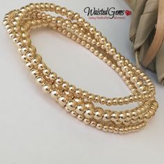 "14k Gold Filled Beaded Bracelet is handcrafted with 14K rose gold filled or 14K yellow gold filled or sterling silver smooth round 2.5mm, 3mm, 4mm & 5mm beads strung on a durable elastic cord a crimp cover bead is used to cover the elastic knot for a seamless finish this one bead will have a seam. These are beautiful, elegant, and modern pieces. They are great for stacking or wearing alone. These bracelets are sold Individually and come in a cute brand box ready for gift giving. If a full s Gold Hand-strung Crystal Bangle Bracelet, Gold Beaded Bracelet Jewelry, Gold Bracelet With Faceted Beads, Hand-strung Gold Bracelet Jewelry, Gold Stretch Bracelet With Faceted Beads, Hand-strung Gold Bracelet With Round Beads, Gold Beaded Rondelle Crystal Bracelet, Gold Hand-strung Bangle Jewelry, Gold Bangle Bracelets With Polished Beads