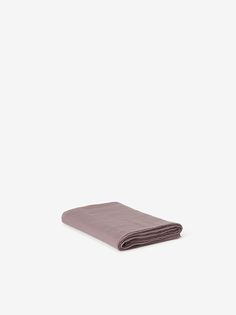 a folded purple towel on a white background