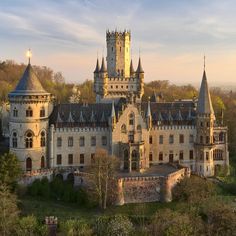 an aerial view of a castle in the woods