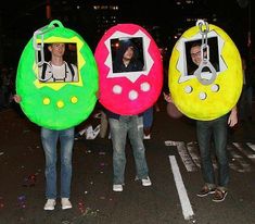 three people are standing in the street with fake doughnuts on their heads and holding photos