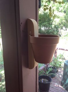 a potted plant hanging on the side of a door