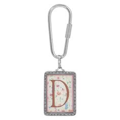 a key chain with the letter d in it's center and flowers on it