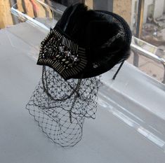 This Black Feather Bronze Studded Crystal Chain Applique Sinamay Fascinator Hat with Veil and Satin Headband is a beautiful accessory for weddings, parties, cocktail, evening, and other special occasions. It is elegant, stylish, sparkling, and super chic! The perfect Fall/Winter piece that will definitely add a fashionable touch to your outfit!! I only accept PayPal and ship all orders within 24 hours via USPS. Feel free to send me a convo with any questions. Thank you for visiting Hettie hair A Adjustable Black Fascinator For Vintage Events, Black Gatsby Fascinator For Parties, Black Gatsby Style Fascinator For Party, Black Gatsby Style Party Fascinator, Gatsby Style Black Fascinator For Parties, Black Flapper Headpieces For Party, Gatsby Style Costume Hat For Kentucky Derby Party, Kentucky Derby Gatsby Style Party Hat, Black Gatsby Headpieces For Party