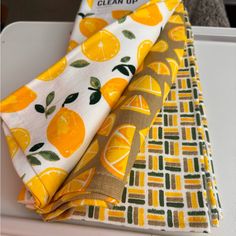 three pieces of cloth with oranges on them