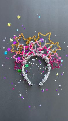 the headbands are decorated with stars and confetti in pink, yellow, and purple