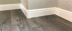 the corner of a room with wood flooring