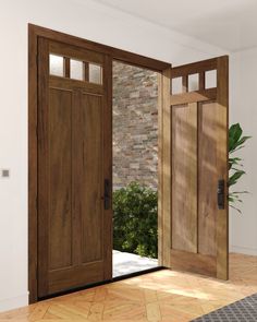 an open wooden door leading to a brick wall and potted plant in the corner