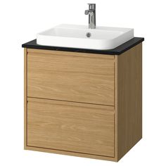 a bathroom vanity with a white sink and black counter top on an isolated white background