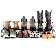 several pairs of shoes are lined up on a rack in front of a white background