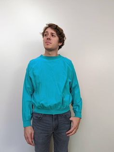 "Vintage 80's Teal Lightweight Pullover Sweater. Long sleeve Quitman Tee. 100% cotton - cotton bands around sleeve cuffs and bottom hem.  Made in USA. Excellent vintage condition. Size on tag: L Measurements taken lying flat: Shoulder to shoulder: 27\" Armpit to armpit: 27\" Length: 24.5\"  Sleeve length: 20\" No returns at this time. Please review all photos carefully and feel free to reach out with any questions." Vintage Ribbed Cuffs Top For Spring, Vintage Tops With Ribbed Cuffs For Spring, Retro Cotton Tops With Ribbed Cuffs, Retro Crew Cotton Sweater, Retro Cotton Crew Sweater, 90s Style Cotton Tops With Ribbed Cuffs, 90s Cotton Tops With Ribbed Cuffs, 1980s Vintage, Leather Coat