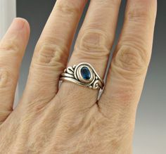 R1124- Sterling Silver Ring with a 5 x 7 mm Royal Blue Kyanite, Size 10 . I can size it to fit, just contact me. No charge to size down, and no charge for one size up. The top of the ring measures 12 mm and the band is 2 mm. This ring is made by the Lost wax Casting method, were I make the design in wax and then cast it into silver. To learn more about Me and the Lost Wax Method please visit my website at www.denimanddiamondsjewelry.com Thanks for visiting, If you have any questions please feel Hand Forged Oval Sapphire Ring For Anniversary, Hand Forged Blue Sapphire Ring For Anniversary, Hand Forged Blue Sapphire Ring Gift, Anniversary Blue Hand Forged Sapphire Ring, Blue Hand Forged Rings For Anniversary, Hand Forged Blue Rings For Anniversary, Blue Hand Forged Rings As Gift, Hand Forged Sterling Silver Blue Ring, Kyanite Ring