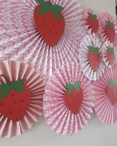 some paper strawberries are sitting on top of each other