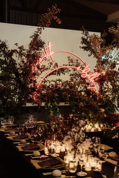 a long table is set up with candles and place settings for an elegant dinner party