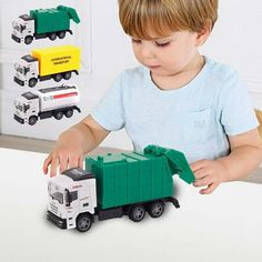 a little boy playing with toy trucks on the table