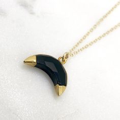 Black Onyx Crescent moon necklace in 18k gold or silver plating. Perfect necklace for layering, or alone for everyday wear! Onyx is a natural stone that comes in several different colors. This necklace is black onyx with gold or silver plating, an go with any outfit! Since ancient times Onyx is believed to absorb negative energy. Because onyx is found in nature, each piece is unique! The stone you receive may be different from the one pictured, but will still be a natural onyx stone. Gold Plated Black Crescent Necklaces As Gift, Black Crescent Necklaces For Gift, Black Moon Phase Necklace For Gift, Elegant Onyx Stone Necklace, Elegant Black Moon Phase Necklace, Black Round Necklace With Moon Charm, Black Round Pendant Jewelry With Moon Charm, Elegant Black Crescent Necklace, Black Moon Charm Round Pendant Jewelry