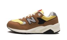 The New Balance 580 “Workwear” is a colorway of the retro running shoe with a rugged appearance inspired by workwear clothing.  The design features a yellow mesh base contrasted with brown suede overlays throughout the upper.  A grey “N” logo appears on either side of the shoe.  White “New Balance” branding is embroidered on the silver leather heel tab.  “NB 580” detailing is found on the tongue.  The shoe’s chunky, black rubber midsole completes the look. Honeycomb Raw, New Balance 580, White New Balance, Retro Running Shoes, Work Wear Outfits, Japanese Store, Balance Sneakers, Black Gums, Stadium Goods