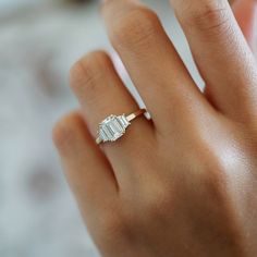 a woman's hand with a diamond ring on it