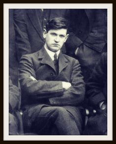 an old black and white photo of a man with his arms crossed in front of him