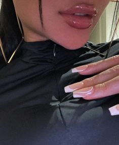 a close up of a woman with long nails