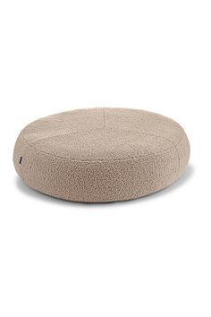 the round dog bed is made out of plush material