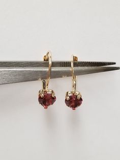 "Thanks for shopping our vintage estate store. We tend to sell well below wholesale and truly hope you enjoy all of our items. Many of the items are one of a kind, so please enjoy scrolling through the pictures and hopefully something will catch your eye. Brown spots are from camera or reflections. Nice estate 14k yellow gold natural 1ct garnet heart lever back earrings. Length: 5/8\" Width: 1/4\" Weight: .85 grams Gem: 5mm 1/4\" each Beautiful earrings, marked 14k." Classic Dangle Heart Earrings For Anniversary, Garnet Heart, Baby Rings, Brown Spots, Cushion Cut Ring, Garnet Earrings, Engagement Anniversary, Cute Rings, Pinky Ring