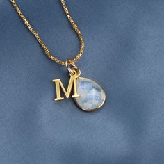 This genuine moonstone birthstone necklace symbolises happiness and self-confidence. Our 18 carat gold vermeil pendant features a real moonstone gemstone at its centre.  Our real moonstone gemstone is carefully cut in facets to show off the light-reflecting properties of the stone.  DETAILS:  * Real Moonstone gemstone. *  Crafted in 18 carat gold vermeil * Moonstone gemstone measures 13mm x 10mm. * Can be personalised with your initial charm.  * Chain: Choose from 16, 18, 20, 24 and 30 inch medi Yellow Gold Moonstone Jewelry With Birthstone, Yellow Gold Moonstone Necklace With Round Pendant, Gold Moon Shaped Gemstone Necklace, Gold Moonstone Necklace As Gift, Gold Moonstone Necklace For Gift, Dainty Moonstone Charm Necklace For Gift, Yellow Gold Moonstone Pendant Necklace, Gold Gemstone Necklace With Moonstone, Gold Moonstone Gemstone Necklace