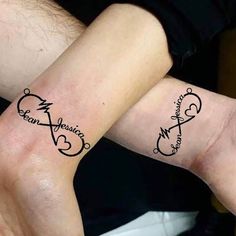 two people with matching tattoos on their arms, one is holding the other's hand