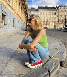 a woman sitting on the ground with her legs crossed