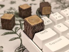 several pieces of wood sitting on top of a white computer keyboard with the keys turned upside down