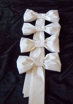 the white bow is tied up on the black cloth