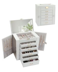 an open white jewelry box with drawers