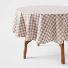 a brown and white checkered tablecloth with wooden legs