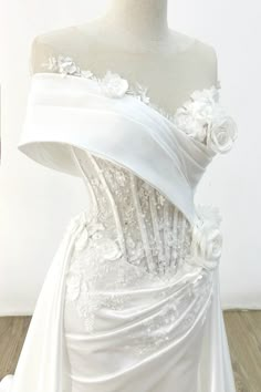 a white wedding dress on a mannequin