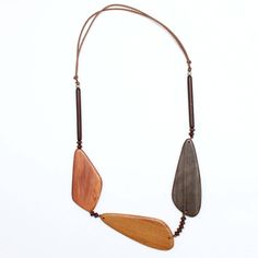 Three geometric wood beads make up this neutral palette statement necklace. The large wood beads are accented with small beads between each and finished off with bar beads topped with a silver ball bead. The necklace hangs on an adjustable brown wax cord. The neutral palette makes this necklace easy to pair with any outfit. Adjustable length: 24″-28″ Largest bead: 3.5″L x 1″ W Everyday Brown Necklace With Adjustable Length, Brown Adjustable Length Necklace For Everyday, Adjustable Brown Wooden Necklaces, Everyday Brown Wooden Beaded Necklaces, Brown Mustard, Small Beads, Wood Necklace, Beaded Top, Neutral Palette