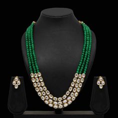 Enhance your outfits with our dignified Ruhi kundan necklace set made with kundan, green beads, and gold plating. This necklace and earrings jewelry set has sophisticated appeal that's perfect for all occasions. Specifications Materials used: kundan, green beads, gold plating Length: 46 cm (necklace), 2.5 cm (earrings) Weight: 120 grams Sold Out! At Romikas, we pride ourselves on the craftsmanship and high quality of our jewelry, designed to enhance your natural beauty. Please contact us with an Festive Green Kundan Necklace, Green Kundan Necklace With Cutdana For Diwali, Green Kundan Cutdana Necklace For Diwali, Festive Green Beaded Kundan Necklace, Green Kundan Beaded Necklace With Cutdana, Green Kundan Beaded Necklaces For Diwali, Festive Green Kundan Mala, Green Temple Jewelry Mala For Festive Occasions, Festive Green Emerald Kundan Necklace