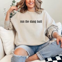 Stay warm and show your team pride with our Run the Dang Ball Sweatshirt. Perfect for Bulldogs fans, it features the iconic phrase and references our beloved UGA football team. Get ready to cheer them on in style! Relaxed Fit Screen Print Sweatshirt For Game Day, Team Name Sweatshirt For Fan Merchandise In Relaxed Fit, Fan Merchandise Letter Print Relaxed Fit Sweatshirt, Fan Merchandise Letter Print Relaxed Sweatshirt, Relaxed Fit Sweatshirt With Text Print For Game Day, Relaxed Fit Text Print Sweatshirt For Game Day, Letter Print Relaxed Fit Sweatshirt For Fans, Relaxed Fit Letter Print Sweatshirt For Fans, Team Spirit Sweatshirt With Screen Print