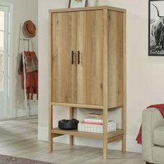 a wooden cabinet sitting next to a couch in a living room