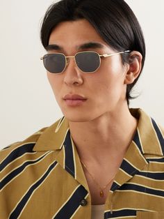 Bottega Veneta Eyewear's round-frame sunglasses feel both classic and modern. They're made from gold-tone metal that's polished to a high shine and have sleek dark lenses and acetate tips at the arms. Modern Gold Round Frame Sunglasses, Classic Gold Sunglasses With Tinted Lenses, Classic Gold Tinted Sunglasses, Classic Yellow Gold Tinted Sunglasses, Gold Tinted Classic Sunglasses, Classic Yellow Gold Polarized Sunglasses, Classic Yellow Gold Sunglasses With Polarized Lenses, Everyday Gold Sunglasses With Metal Frame, Modern Gold Aviator Sunglasses With Tinted Lenses