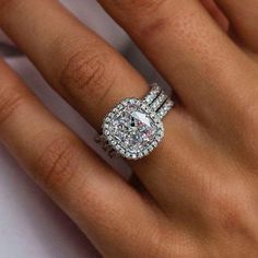 a woman's hand with a diamond ring on it