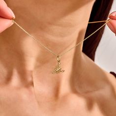 Elevate your elegance with our Scorpion Necklace, a striking piece designed for the bold and sophisticated woman. Perfect for adding a touch of fierce glamour to any outfit, this necklace is a must-have accessory for those who dare to stand out. - Made in 14k Solid Gold - Pendant: 11.90x8.45 mm / 0.47x0.33 inches- Thickness: 2.20mm / 0.09 inches -This product comes with iconic Norm Jewels gift box Elegant Metal Charm Necklace With Clavicle Chain, Trendy Gold Plated Dangle Necklaces, Chic Metal Necklaces With Snake Chain, Chic Metal Snake Chain Necklaces, Chic Metal Necklace With Snake Chain, Dainty Snake Chain Necklace For Party, Chic Clavicle Chain Choker Jewelry, Formal Initial Pendant Necklace, Elegant Formal Necklace With Initial Pendant