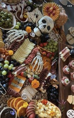 a table topped with lots of different types of foods and desserts next to each other