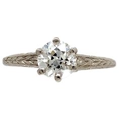 an antique style diamond ring with filigrees