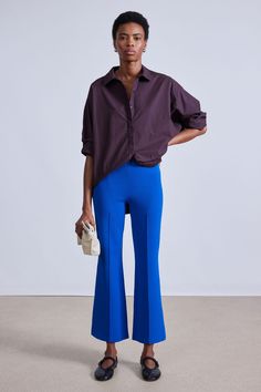 70% Viscose, 30% GRS Recycled Nylon Made in China Elastic waistband, center front and back seam detail, kick flare Dry clean only Inseam: 26 3/4” Size S front rise: 10 1/2" Runs large, we suggest sizing down Model is 5'10 and wearing a size small Blue Flare Pants In Elastane, Blue Flare Pants With Elastane, Modern Blue Bottoms For Fall, Chic Blue Flare Wide Leg Pants, Blue Flare Pants For Work, Modern Fitted Blue Bottoms, Modern Wide Leg Blue Bottoms, Chic Blue Mid-rise Wide Leg Pants, Modern Blue Spring Pants