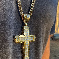 Huge iced cross pendant hip hop chain. 30" x 8mm cuban chain with a lobster lock. 18k gold plated over heavy alloy metal core.. Huge pendant is 5" tall w/bale and 2.75 wide. Pendant iced with dazzling round-cut stones. Sturdy well made pendant has a caged back. Solid piece has good weight at 180 grams. 100% FREE SHIPPING in USA. Order now! Streetwear Jewelry: Cross Pendant Chain, Streetwear Jewelry With Cross Pendant Chain, Streetwear Cross Pendant Chain Jewelry, Gold Iced Out Cross Pendant Jewelry, Iced Out Gold Cross Pendant Jewelry, Gold Iced Out Cross Pendant Necklace, Hip Hop Chains, Cuban Chain Necklace, Metal Core