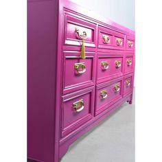 a pink dresser with gold handles and knobs on the drawers is shown in this image