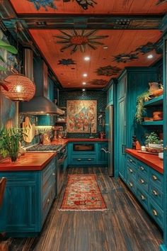 the kitchen is painted teal and has wooden floors, blue cabinets, and an area rug on the floor