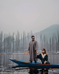 a man and woman in a boat on the water