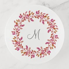 a personalized monogrammed plate with pink leaves and the letter m on it