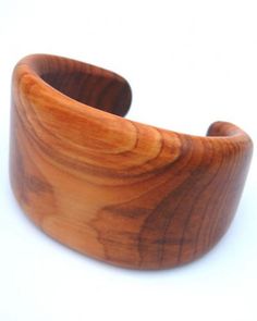 a wooden bracelet is shown on a white surface